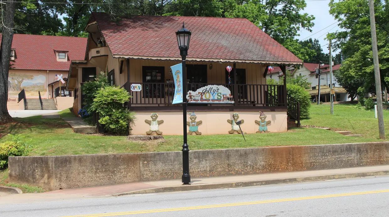 A red-roofed shop in Helen with gingerbread-man cutouts along its front wall and an old-style street lamp outside.