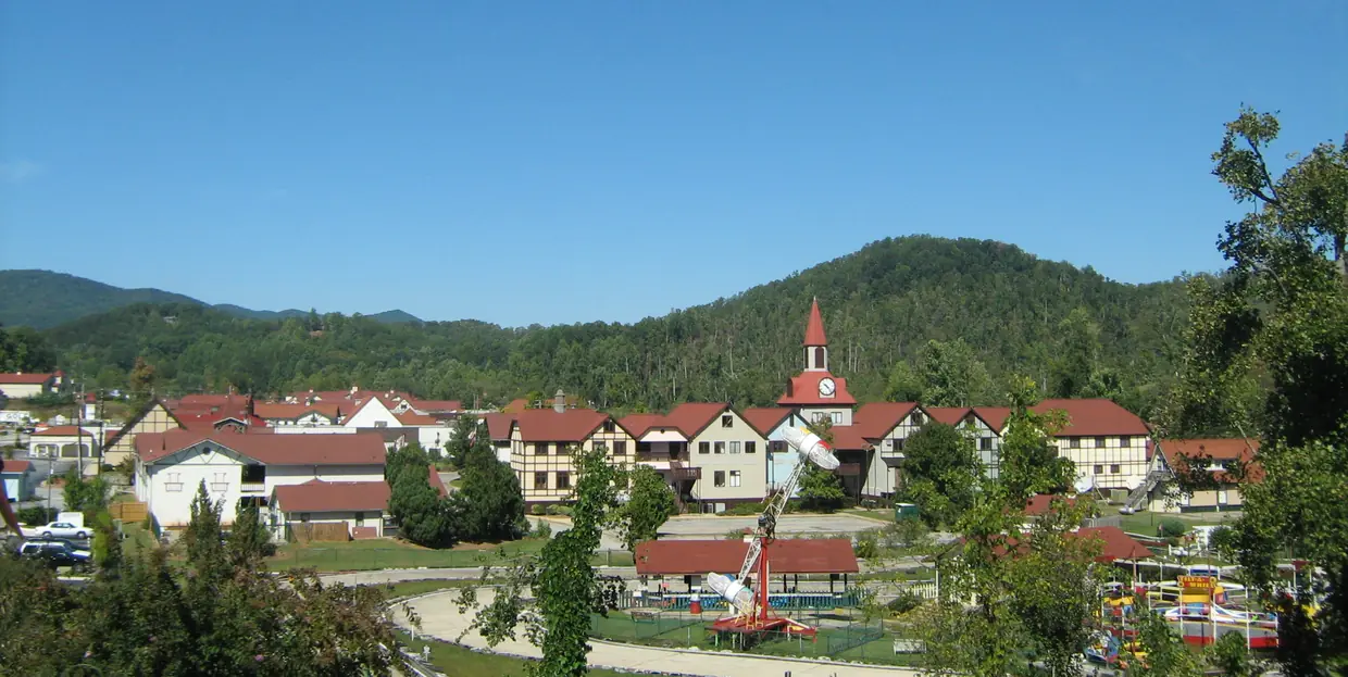 Helen's red roofs spread across the valley floor below forested hills, a white church steeple rising among them.